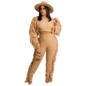 Close-up of boho fringe knit two-piece set with waffle texture and long tassels