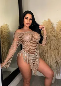 Sexy hand-woven crochet beach dress featuring large mesh pattern and long fringe details