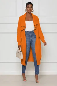 Elegant long orange knit cardigan for women styled with blue jeans and white top