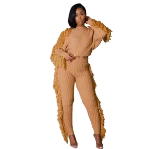 Stylish camel-colored knitted two-piece set featuring long sleeves and bold fringe trim