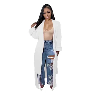 Macro view of women's long white knit cardigan sweater with elegant fringe detail