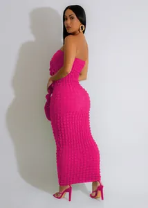 Detailed side view of fuchsia bubble textured strapless bodycon maxi dress for women