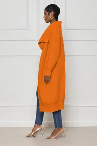 Side view of long orange knitted cardigan showing ribbed texture and wide collar