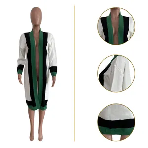 Close-up of women's long knit cardigan with green, black and white color blocking details