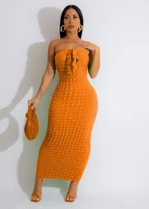 Full length view of an orange tube top maxi dress featuring textured bubble fabric