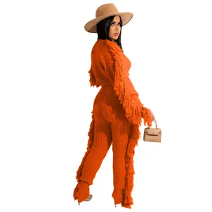 Detail view of casual orange knit fringe set for women with long sleeves and pants