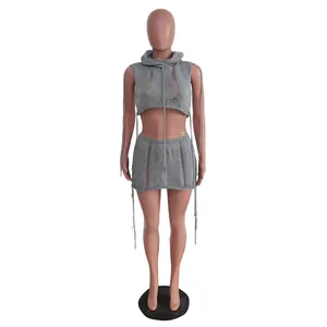 Detail view of grey knitted sleeveless hooded crop top and distressed mini skirt set.