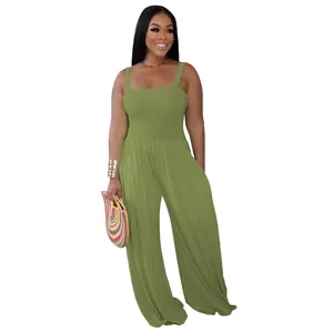 Full body shot of olive green jumpsuit showing smocked texture and wide-leg cut.