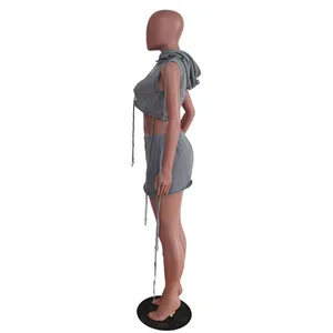Side view detail of women's grey sleeveless hooded knit crop top and mini skirt set