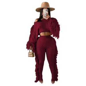 Full view of women's burgundy knit two-piece set featuring long sleeves with fringe detail.