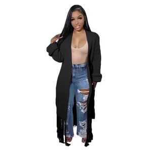 Detail view of women's black long cardigan featuring stylish fringe tassel hem