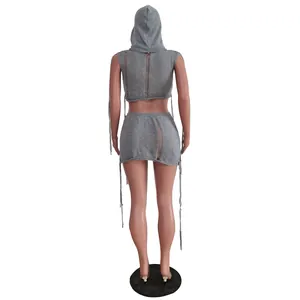Detailed back view of a gray knit sleeveless hooded top and distressed mini skirt set
