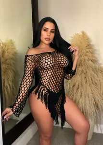 Close-up view of black crochet mesh beach cover-up with long sleeves and fringe tassels
