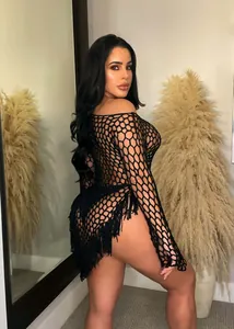 Detailed view of black hand-woven large mesh beach dress with sexy tassel hem decoration