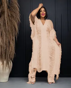 Close-up of beige handmade knit fringe set with hollow design on model