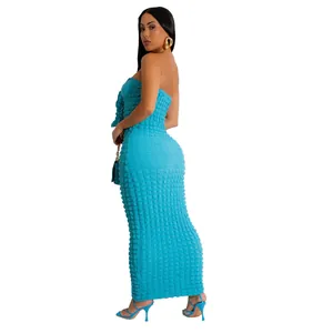 Detailed side view of a blue textured bubble fabric strapless bodycon maxi dress.