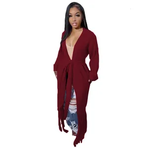 Full body shot of a long burgundy cardigan featuring fringe details and waist tie