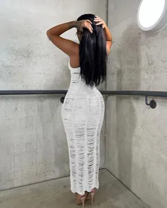 Back view of a chic white knitted hollow-out bodycon maxi beach dress for women's fashion