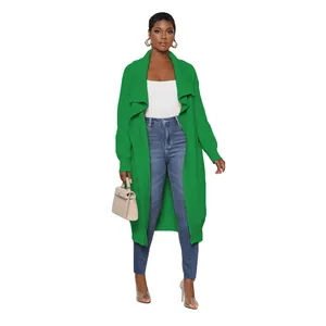 Women's casual long-line green knit cardigan jacket styled with jeans and white top.