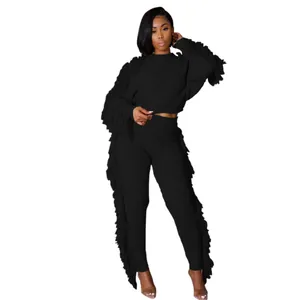 Detailed view of women's black knit long sleeve set with stylish fringe trim