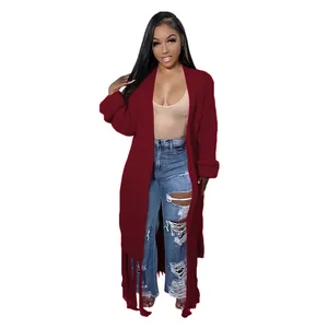 Detailed view of women's long burgundy cardigan sweater with fringe trim