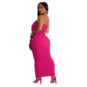 Side view detail of a pink strapless bodycon maxi dress in textured bubble fabric