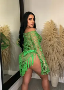 Detail showing texture of sexy neon green hand-crocheted fishnet beach dress with long fringes