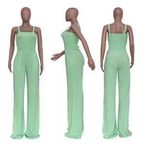 Detailed front, side and back views of a mint green smocked wide-leg jumpsuit