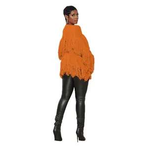 Back view of orange knit cardigan with dense fringe details and short cut design.