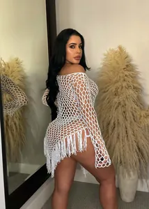 Detailed view of sexy white hand-knit large mesh beach dress with tassels on a model