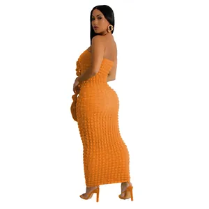 Detail view showing textured orange slim fit bubble fabric strapless maxi dress for women