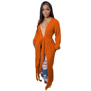 Full view detail of a vibrant orange long-line knitted cardigan with fringe hem and waist tie