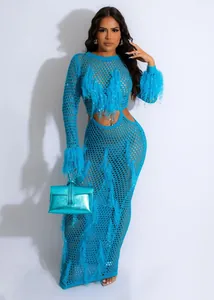 Detail view of turquoise crochet mesh beach dress with feather fringe and matching handbag