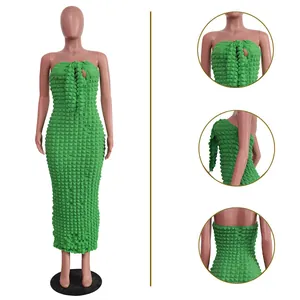Detailed view of green popcorn fabric strapless maxi dress showing textured patterns