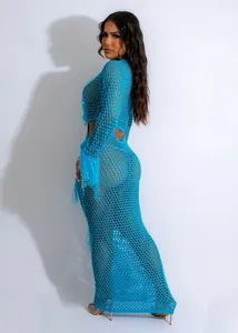 Detailed view of the bright blue crochet knit pattern and fringe sleeves of this beach maxi dress.