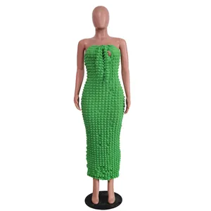 Close-up detail of green popcorn textured fabric on strapless bodycon maxi dress