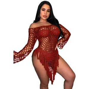 Detail of the sexy red crochet fishnet beach dress featuring long sleeves and fringe tassels