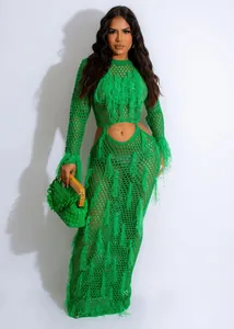 Detailed view of green hollow-out knitted maxi dress with fringe tassels for beachwear