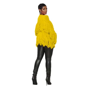 Detail view of yellow knitted cardigan featuring tiered fringe and cropped length