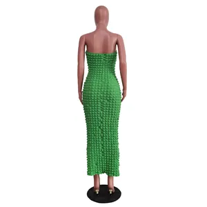 Detailed back view of a green strapless bodycon maxi dress in textured bubble fabric