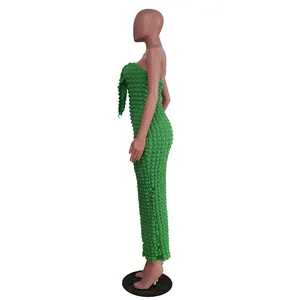 Detailed side profile of a green bubble fabric strapless slim fit maxi dress on a mannequin