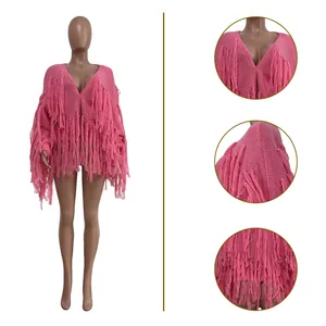 Detail view of pink knit cardigan with layered fringe and V-neckline texture.