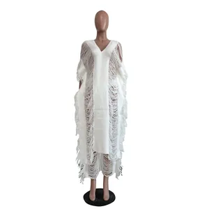 Close-up front view of a white handmade knitted dress featuring a hollow tassel design.