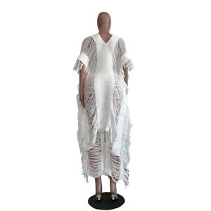 Back view of a white handmade knitted hollow-out dress with fringe tassels