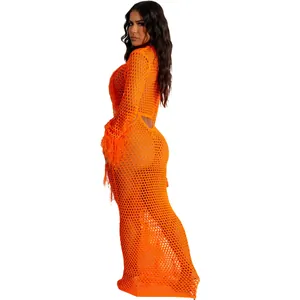 Side view detail of vibrant orange crochet hollow-out beach maxi dress with fringes