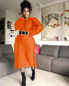 Chic long orange knitted sweater dress with fringe tassels and black belt detail.