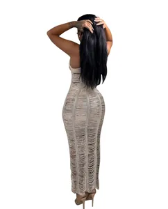 Back view of a chic beige knit hollow-out maxi dress featuring laddered beach texture