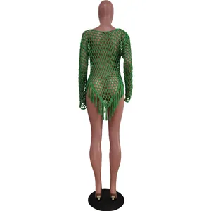 Back view of a sexy green hand-knitted mesh beach cover-up with long fringe tassels
