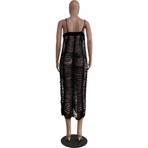Back view detail showing the intricate black knit hollow out fringe beach maxi dress