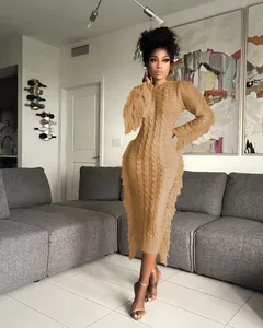 Elegant camel long-sleeved cable-knit sweater dress featuring stylish fringe trim detail